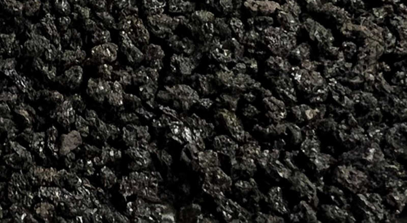 Macro photograph of basalt-derived volcanic soil aggregates from Mount Etna with mineral fragments and ash particles