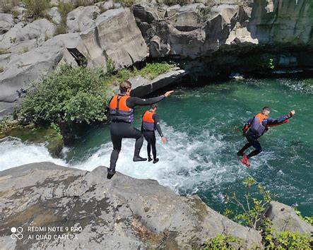 participants navigating volcanic pools