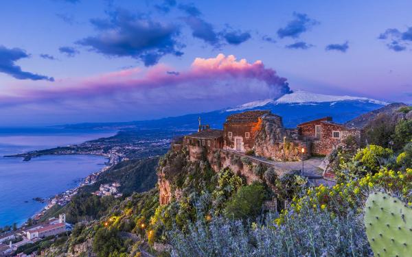 a view of the church of Madonna Rocca with mount Etna on the background